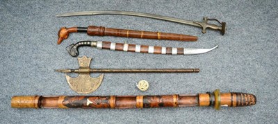 Lot 372A - An Indonesian Golok, with 54cm single edge fullered steel blade, the horn hilt carved as the...