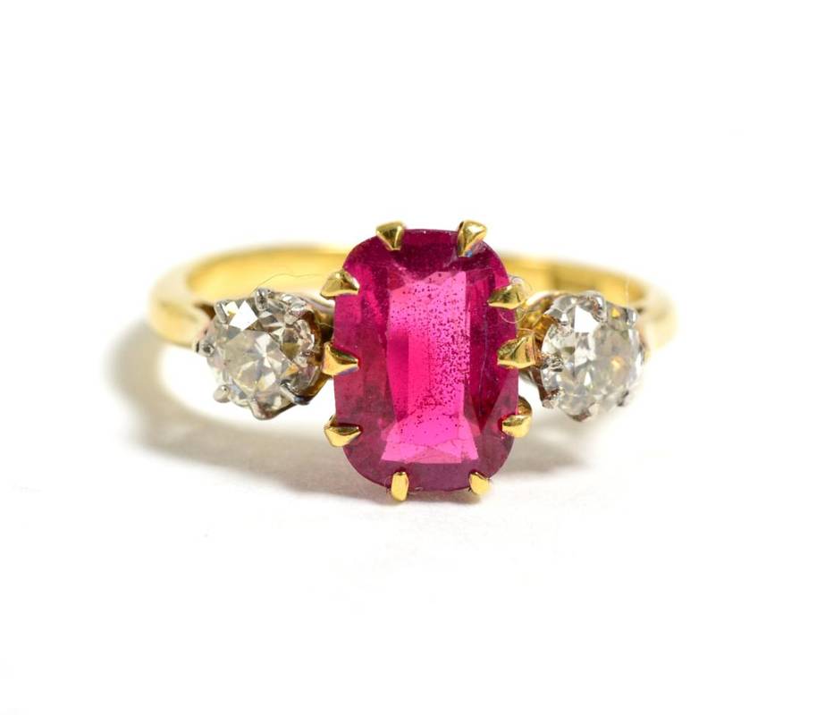 Lot 21 - A synthetic ruby and diamond three stone ring, a rectangular cushion cut synthetic ruby in a...