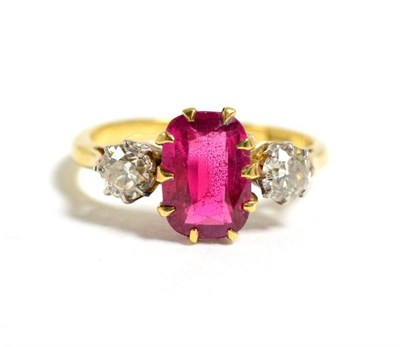 Lot 21 - A synthetic ruby and diamond three stone ring, a rectangular cushion cut synthetic ruby in a...