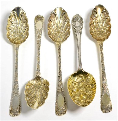 Lot 32 - Four George III silver table spoons, later decorated to match as berry spoons; and a Victorian...