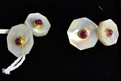 Lot 35 - A pair of gilt metal mother of pearl; and a pair of ruby cabochon double cufflinks