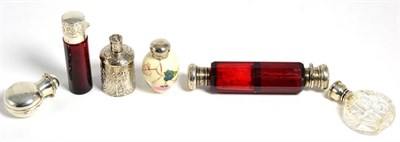 Lot 39 - A group of silver and white metal mounted scent bottles, comprising: a foliate painted...