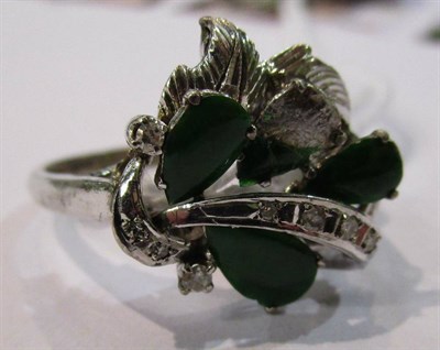 Lot 46 - A jade ring, with tapering pierced shoulders, finger size N, stamped '18K' and with Chinese...