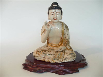Lot 188 - A Satsuma Earthenware Figure of Buddha, late 19th century, sitting in the lotus position with...