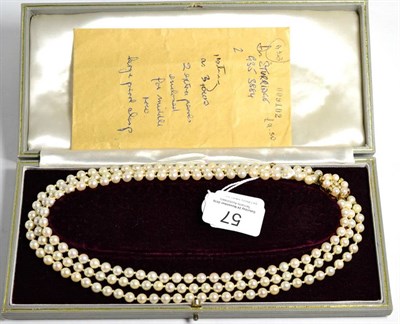 Lot 57 - A triple strand cultured pearl necklace, uniform cultured pearls knotted to a 9 carat gold cultured
