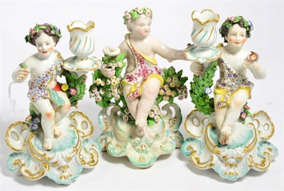Lot 83 - A Derby porcelain figural chamberstick, circa 1775, modelled as a cherub sitting on a tree...