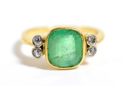 Lot 121 - An emerald and diamond ring, an octagonal cut emerald in a rubbed over setting, spaced by pairs...