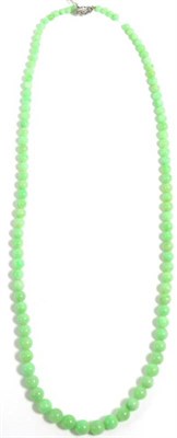 Lot 145 - A jade necklace, with a diamond set clasp, graduated jade beads knotted to a milgrain set old...