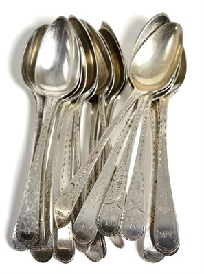 Lot 164 - A set of six George III silver bright-cut teaspoons, London, 1792; another set of six, London,...