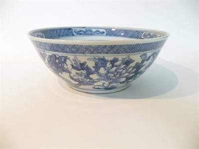 Lot 204 - A Chinese Porcelain Bowl, 19th century, painted in underglaze blue with dragons amongst foliage...