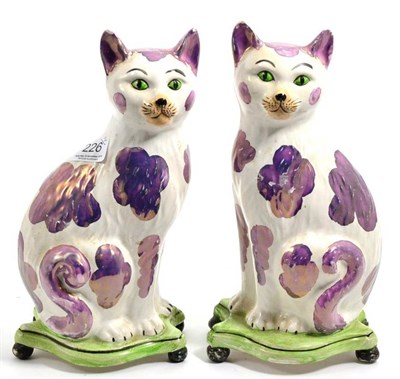 Lot 226 - A pair of pink lustre models of seated cats