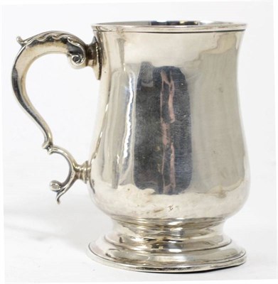 Lot 249 - A George III silver mug, George Smith, London 1786, plain baluster form with leaf capped scroll...