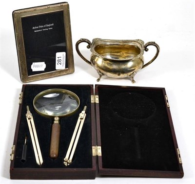 Lot 281 - A silver twin handled sugar; a silver photograph frame; and a US Navy navigation set, boxed