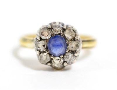 Lot 286 - A sapphire and diamond cluster ring, an oval cut sapphire within a border of old cut diamonds,...