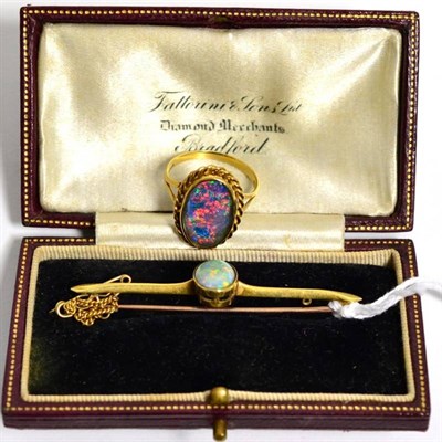 Lot 298 - An opal bar brooch, stamped '15CT', 4.7g and a 9 carat gold opal doublet ring, finger size...