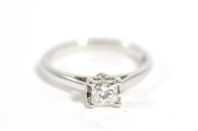 Lot 318 - An 18 carat white gold princess cut solitaire diamond ring, finger size J1/2, 2.7g  Accompanied...