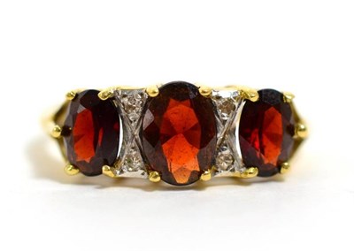 Lot 338 - A garnet and diamond ring, finger size M, 2.8g