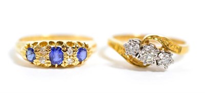 Lot 359 - An 18 carat gold sapphire and diamond ring, finger size K1/2 and a diamond three stone ring,...