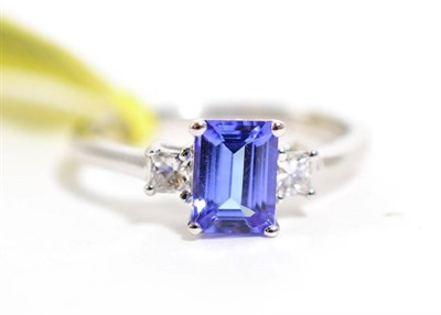 Lot 361 - An 18 carat gold tanzanite and princess cut diamond three stone ring, total estimated diamond...