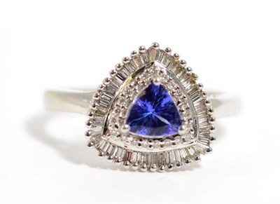 Lot 362 - An 18 carat gold tanzanite and diamond cluster ring, total estimated diamond weight 0.50 carat...