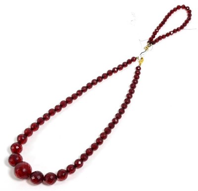 Lot 364 - A graduated faceted red plastic bead necklace and matching bracelet (2)