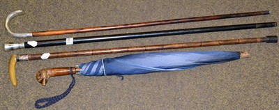 Lot 398 - Three various walking sticks and a parasol with carved bird head handle (4)