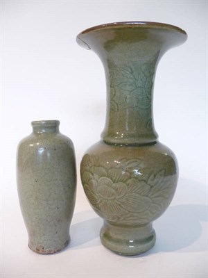 Lot 229 - A Chinese Celadon Glazed Vase, late Ming Dynasty, with trumpet neck and baluster body, incised with