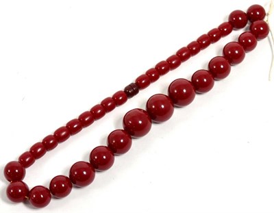 Lot 495 - A strand of red bakealite beads