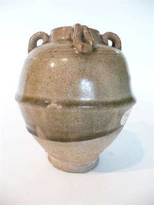 Lot 235 - A Chinese Olive Green Glazed Ovoid Jar, possibly Tang Dynasty, with four lug handles, the...