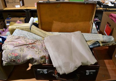 Lot 1028 - A quantity of fabric; table cloth; and a suitcase