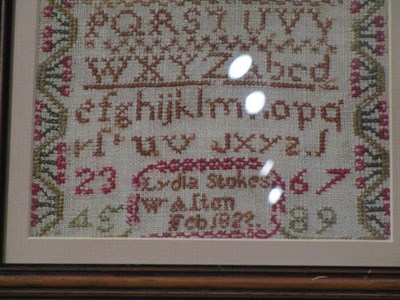 Lot 1046 - A 19th century alphabet sampler, by Lydia Stokes, dated 1822, designed with a pot of flowers...
