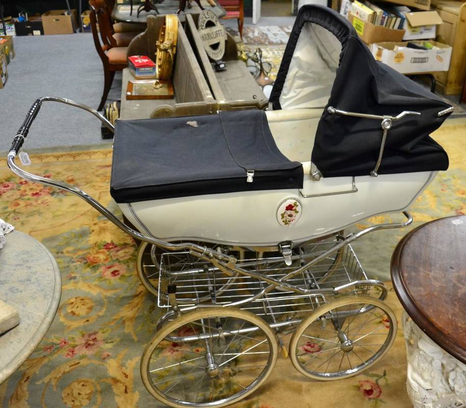 Lot 1075 - Silver Cross pram, with oval porcelain floral plaques, blue hood and cover