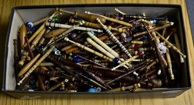 Lot 1104 - Assorted lace makers bobbins, including wooden examples with metal inlay and metal stringing,...