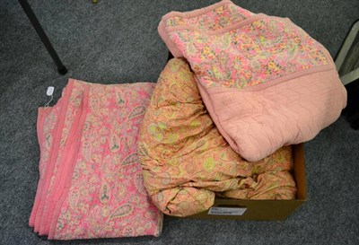 Lot 1117 - Pink whole cloth quilt with paisley and floral reverse, 210cm by 170cm; another similar with...
