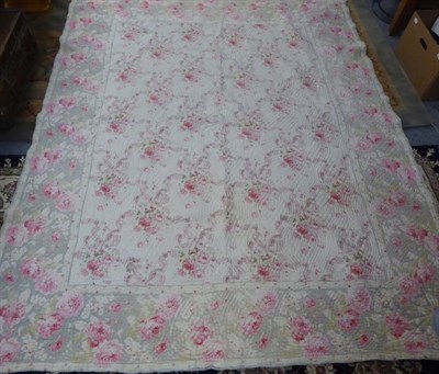 Lot 1125 - Late 19th century floral quilt with pale blue reverse, and another in yellow (2)