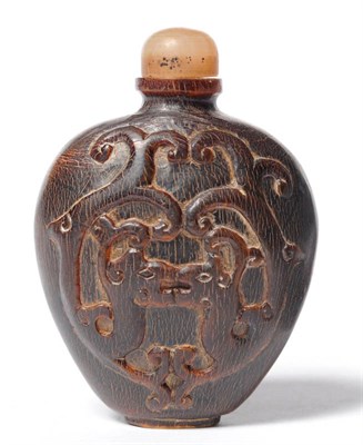 Lot 248 - A Chinese Carved Horn Snuff Bottle, Qing Dynasty, circa 1750-1850, of shouldered blade form, carved