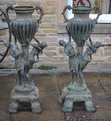 Lot 1367 - A pair of cast bronze ornamental garden urns of figural supports