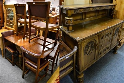 Lot 1400 - A 1940's carved oak sideboard; drop leaf dining table; and a set of six chairs