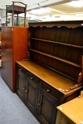 Lot 1402 - A reproduction oak dresser, by Banks of Bristol; a piano stool; and a modern yew filing cabinet (3)