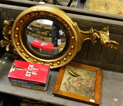 Lot 1431 - A 19th century gilt and gesso convex wall mirror, surmounted by an eagle, re-painted; together with