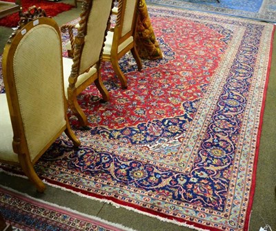 Lot 1444 - Kashan carpet, central Iran, the raspberry field of vines around an indigo pole medallion framed by