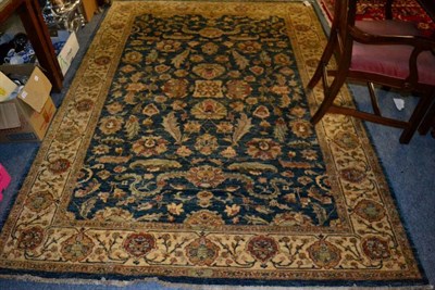 Lot 1449 - Agra design rug, North Afghanistan, the shaded indigo field of flowers and plants enclosed by ivory