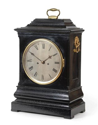 Lot 1479 - An ebonised striking table clock, circa 1850, caddied pediment with carrying handle, side lion head