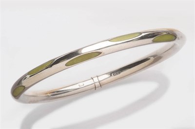 Lot 281 - An Art Deco Silver Bangle, by Charles Horner, 1922, the large polished bangle interspersed with...