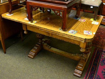 Lot 1500 - A 1940's carved oak pull-out dining table