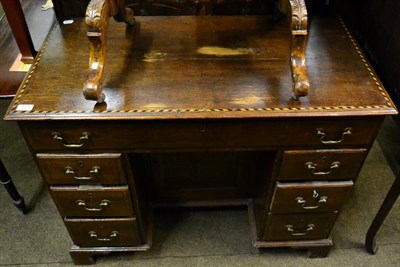 Lot 1507 - A checker-banded oak kneehole desk on bracket feet