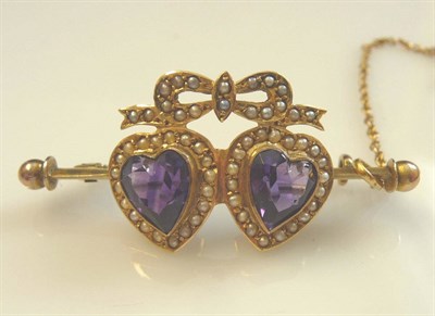 Lot 286 - An Amethyst and Seed Pearl Twin Heart Bar Brooch, two heart shaped amethysts within seed pearl...