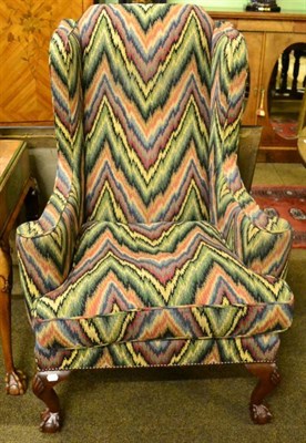 Lot 1540 - A Georgian style wingback armchair by Woods