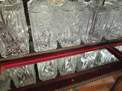 Lot 1542 - A mahogany table top cocktail cabinet containing four decanters, six whisky tumblers and six sherry