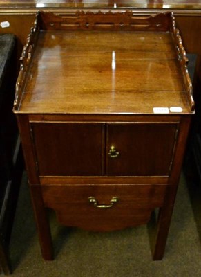 Lot 1578 - A mahogany bedside cabinet with pierced three quarter gallery top